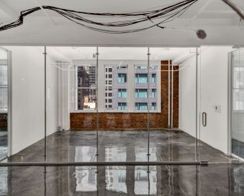 Zar Property has renovated the office spaces with exposed brick walls, polished concrete floors and glass partitions.