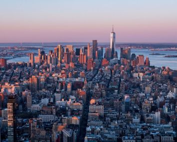 The Manhattan skyline is seen at sunrise from the 86th floor observatory of the Empire State Building on April 3, 2021.