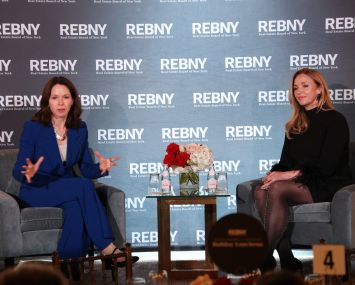 A photo of two people on stage at an event.